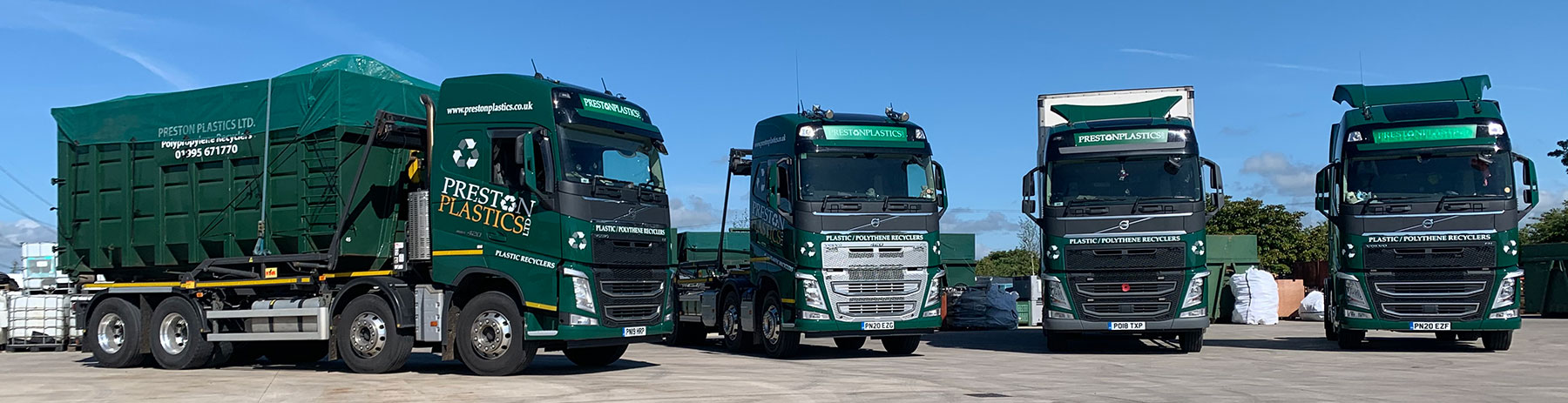 Three black lorries/trucks emblazoned with preston plastics branding