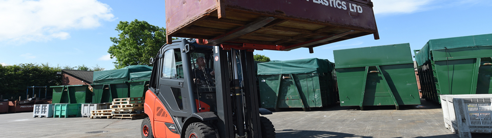 A forklift carrying a crate marked with 'Preston Plastics Ltd.'.